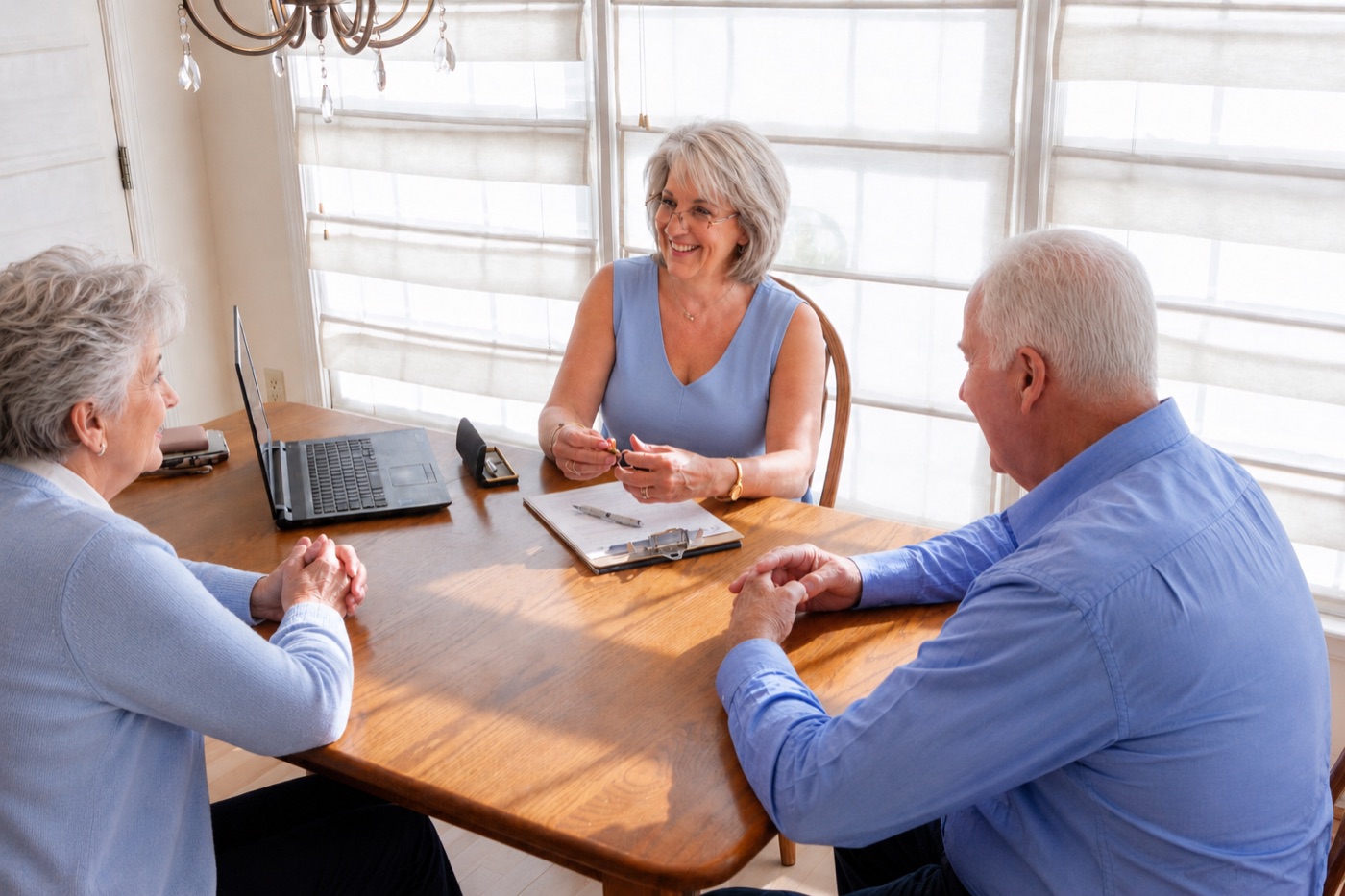 Tammy Wiles reviewing paperwork with clients at the table